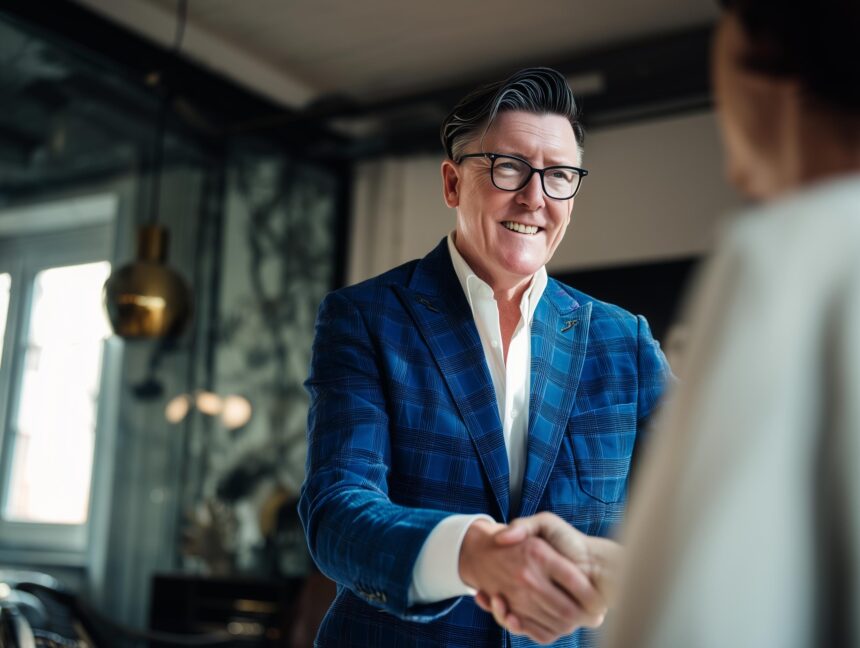 Männlicher CEO gibt Frau die Hand im Büro